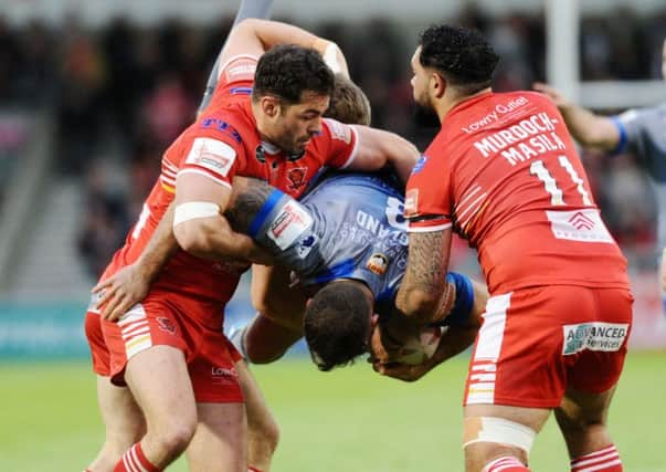Wakefield's Anthony England is brought down to earth by Salford's Kriss Brining, Mark Flanagan and Ben Murdoch-Masila.