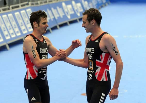OUT IN FRONT: Jonny Brownlee, left, and brother Alistair embrace at the finish line in Leeds last weekend.