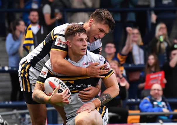 Liam Sutcliffe celebrates scoring the Rhino's sixth try against Featherstone with Tom Briscoe.
