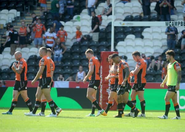 Dejected Casyleford players leave the field after Sunday's Challenge Cup defeat to Hull FC. PIC: Steve Riding