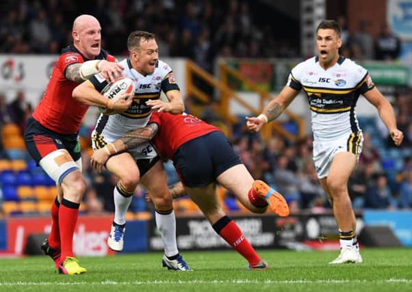 Danny McGuire is held by Richard Moore and Brad Tagg during 
Leeds Rhinos' Challenge Cup quarter-final with Featherstone Rovers.  PIC: Bruce Rollinson
