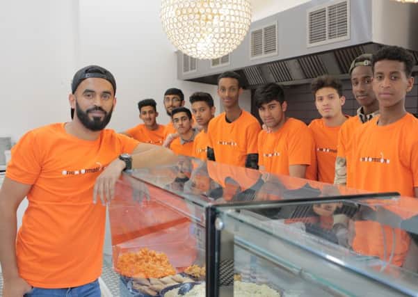 Mushad Ahmed with One Formation members at Ice Scoop Gelato, where they prepared the meals.
