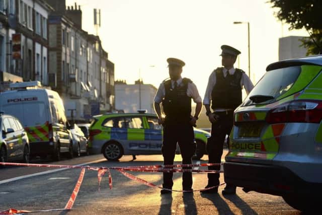 Police officers man a cordon in Finsbury Park, north London, after a van struck pedestrians. PA