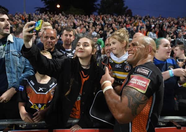 Jake Webster celebrates the Tigers 23-12 win with the fans taking selfies.

Picture: Bruce Rollinson