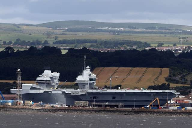 HMS Queen Elizabeth, one of two new aircraft carriers for the Royal Navy sits docked in the sunshine at Rosyth dockyard near Edinburgh ahead of her sea trials which are due to begin. Picture: Andrew Milligan/PA Wire