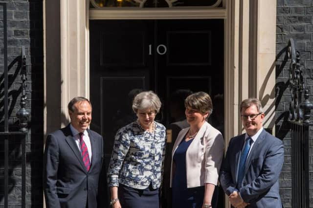 Prime Minister Theresa May greets DUP leader Arlene Foster, DUP deputy leader Nigel Dodds and DUP MP Sir Jeffrey Donaldson outside 10 Downing Street in London ahead of talks aimed at finalising a deal to prop up the minority Conservative Government.