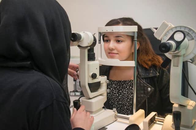 An eye test revealed Niamh Kane had a benign tumour. She is being tested by optometrist Misbah Jabeen