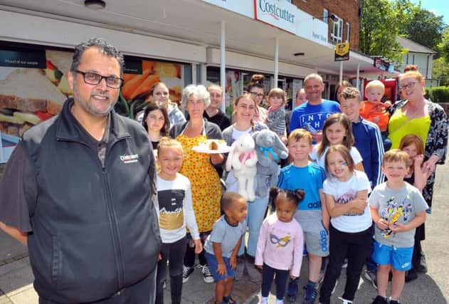 Praff Patel of Costcutter in Ireland Wood, Leeds, with members of the community at the fundraising event for Sorrell Leczkowski. Picture by Steve Riding.
