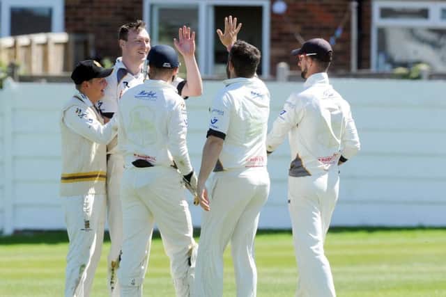 Pudsey St Lawrence bowler Ollie Ashfod, facing, is congratulated after getting the valuable wicket of Tom Hodgson. PIC: Steve Riding