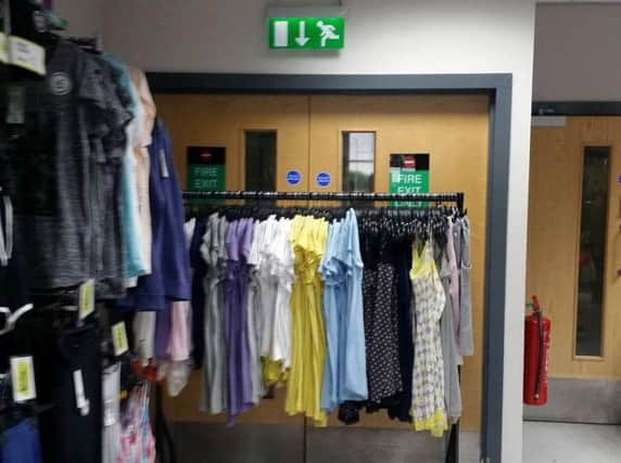 The fire exit door blocked by a clothes rail at Poundland in Doncaster. (Photo: Sean Needham).