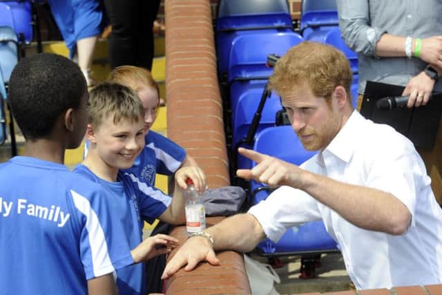 Prince Harry chats to youngsters.