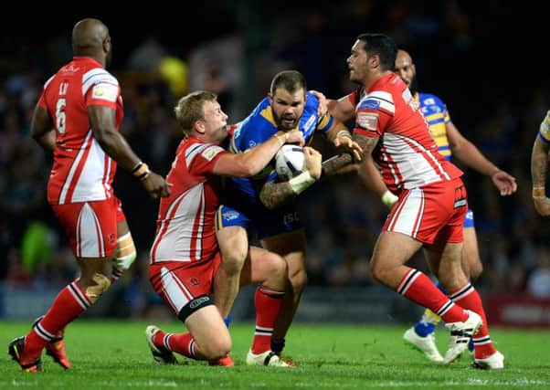 Keith Galloway is tackled by Craig Kopczak and Ben Murdoch-Masila during the Qualifiers clash at Headingley last year.