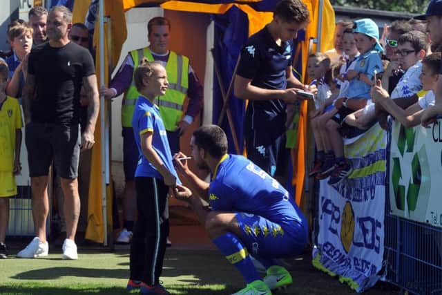 Giuseppe Bellusci autographs a shirt at half-time during Leeds United's pre-season friendly at Guiseley.