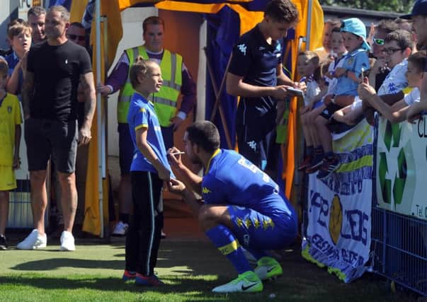 Giuseppe Bellusci autographs a shirt at half-time during Leeds United's pre-season friendly at Guiseley.