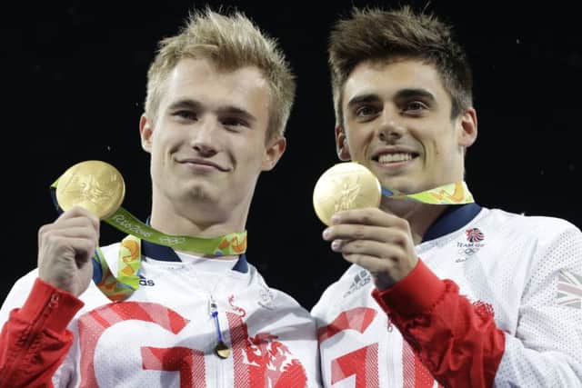 Britain's Jack Laugher, left, and Chris Mears pose with their gold medals after the men's synchronized 3m springboard diving final in the Maria Lenk Aquatic Center at the 2016 Summer Olympics in Rio de Janeiro, Brazil,