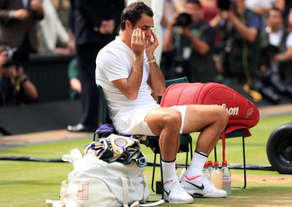 Roger Federer looks emotional following victory over Marin Cilic in the men's final at Wimbledon. Picture: Adam Davy/PA