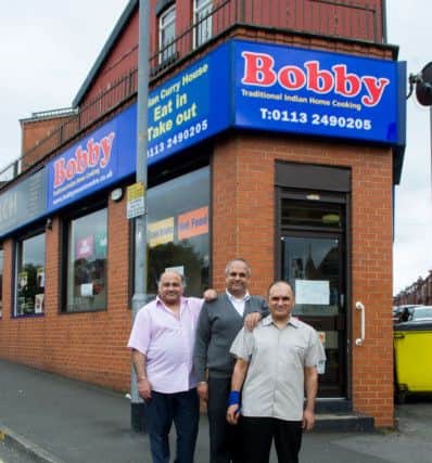 Closing down of Bobby's takeaway, on Roundhay Road, Leeds, after 43 years of business in Leeds. Brothers (left to right) Tajinder, Rajinder, and Narinder Thukral, outside their shop.