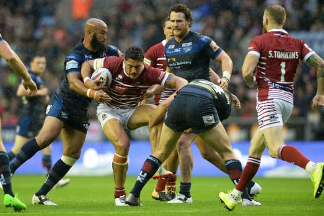 Jamie Jones-Buchanan and Jordan Baldwinson hold Anthony Gelling.