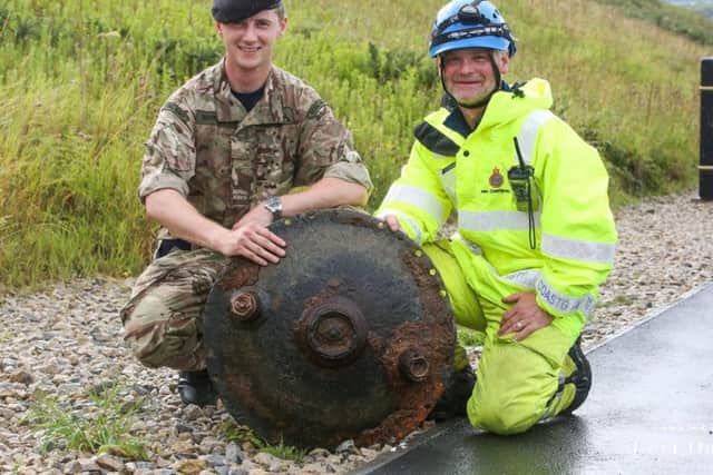 The landmine being posed with by the bomb squad and HM Coastguard. Photo: Ceri Oakes Photography