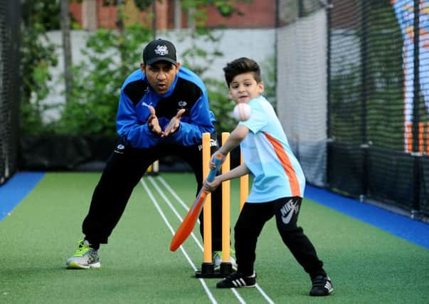 New Yorkshire signing Sarfaraz Ahmed keeps wicket as a young fan at Bradford Park Avenue cricket ground shows off his skills (Picture: Jonathan Gawthorpe).
