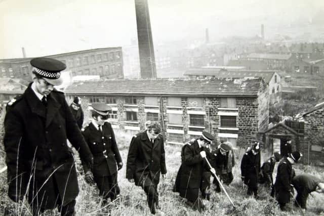 The police search for clues in 1975