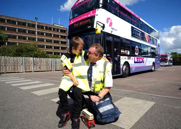 Joshua Craven with bus driver Steve Lamb pictured at First Bus, Hunslet Park Depot. PIC: Simon Hulme