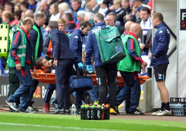 Leeds Gaetano Beradi is stretchered off at Bolton. (Picture: Tony Johnson)