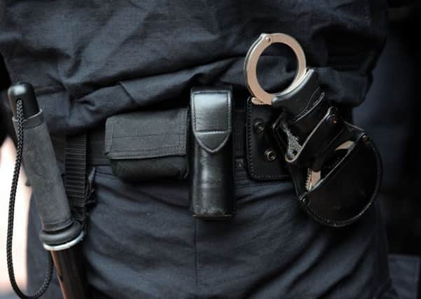 File photo dated 11/08/11 of a baton and handcuffs carried by a police officer. The first detailed statistics on the use of force by police officers are being published from this summer. Photo credit should read: Anthony Devlin/PA Wire