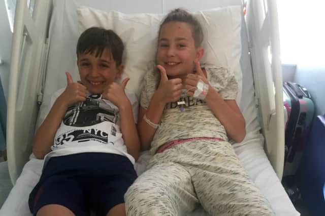 Lola Daley with her brother after she underwent an eight hour operation to have a brain tumour the size of a ping pong ball removed. Picture: The Sick Children's Trust/PA Wire