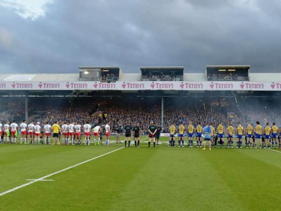 St Helens and Leeds Rhinos players lining up on the pitch. Picture: Steve Riding