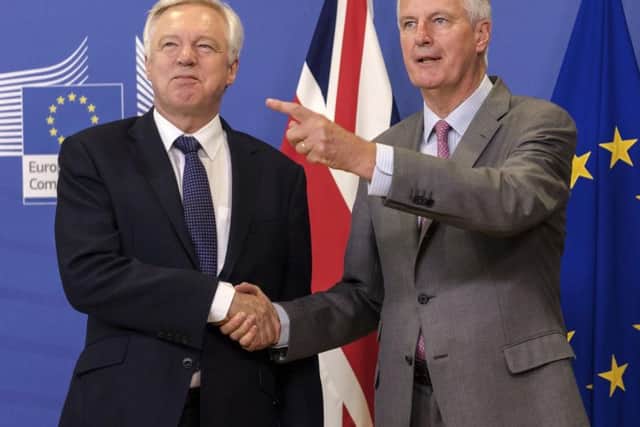 EU chief Brexit negotiator Michel Barnier, right, welcomes British Secretary of State David Davis for a meeting at the EU headquarters in Brussels, Monday July 17, 2017.