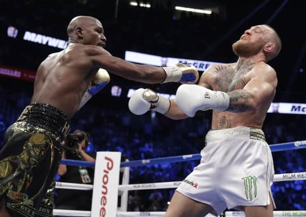 Crunch: Floyd Mayweather Jr catches Conor McGregor in their super welterweight fight.
Picture: AP Photo/Isaac Brekken