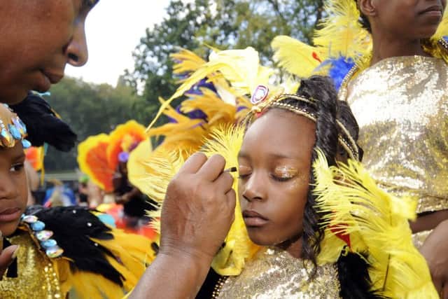 A young dancer has the finishing touches made to their make-up.