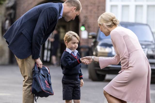 Helen Haslem, head of the lower school greeting Prince George and the Duke of Cambridge at Thomas's Battersea in London, as he starts his first day of school. PIC: PA