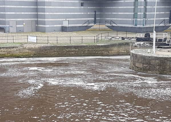 Concerns: Workers at a  business next to the River Aire has seen a substance passing their office.