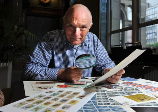 Stamp collector Richard Smith looks at his collection. Picture Tony Johnson.