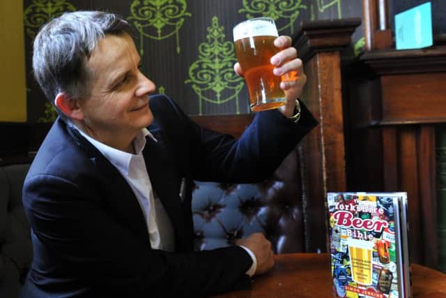 080917 Simon Jenkins checking out a pint at The Fenton on Woodhouse Lane in Leeds , with his new book The Yorkishire Beer Bible.
