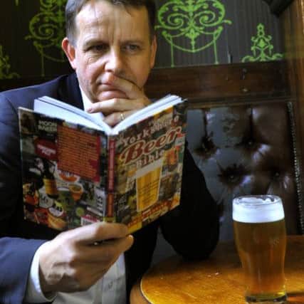080917 Simon Jenkins checking out a pint at The Fenton on Woodhouse Lane in Leeds , with his new book The Yorkishire Beer Bible.