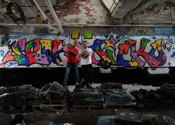New York Graffiti artist George"Sen-One" Morillo (left) pictured with Leeds artist Nicholas Dixon with their artwork at Sunny Bank Mills. Picture by Simon Hulme