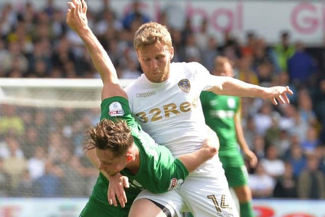 Preston North End's Alan Browne (left) and Leeds United's Eunan O'Kane battle for the ball.