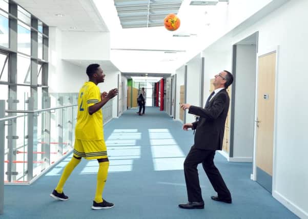 Headteacher Mike Roper plays head tennis with Nasir Friz in the corridor at  Allerton Grange School, which has gone into partnership with Farsley Celtic. Picture Tony Johnson.
