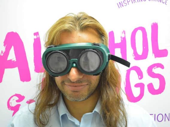 Forward Leeds volunteer Kulwant Mann wearing 'beer goggles' which illustrate how a person's vision is affected by drinking.