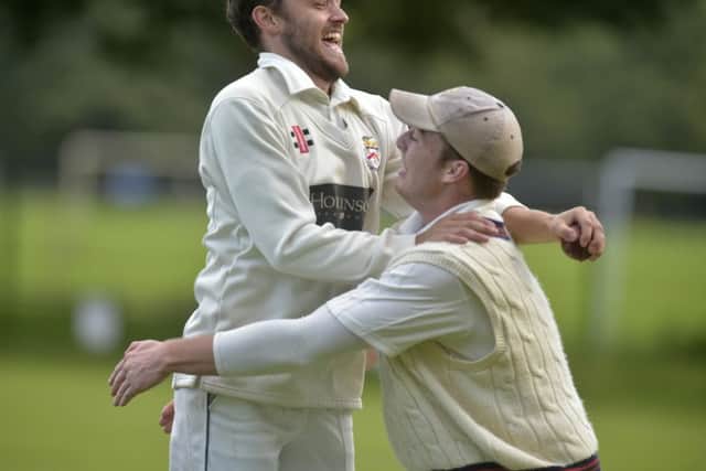 Beckwithshaw captain 
Alex Lilley celebrates with Olly Hodgkiss after catching the sixth North Leeds wicket of Andrew Carsons for 33 off the bowling of Eugene Burzler. The sixth wicket gave them the bonus point needed to win the league. PIC: Steve Riding