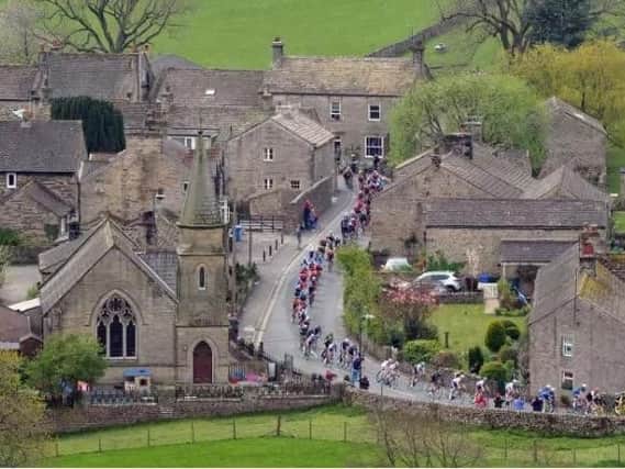 The Peloton passes through Burnsall in the Yorkshire Dales on the last leg of the race from Bradford to Sheffield this year. Picture: Tony Johnson