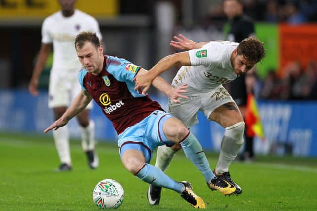 Leeds's Gaetano Berardi battles for the ball with Burnley's Ashley Barnes on Tuesday night at Tuf Moor. Picture: Richard Sellers/PA