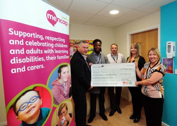 FUNDS:  First Response Groups Mark Hullah presents a cheque to Leeds Mencaps Catherine Storey.