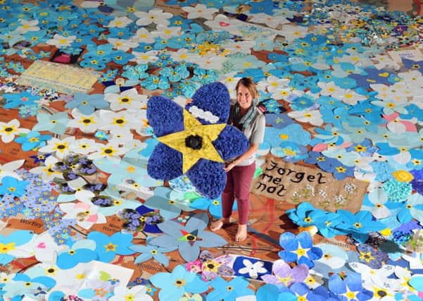 26 September 2017......    Natalie Haigh from the Leeds City Museum where forget-me-nots have been made by organisations and people in Leeds to raise awareness of dementia. Picture Tony Johnson.