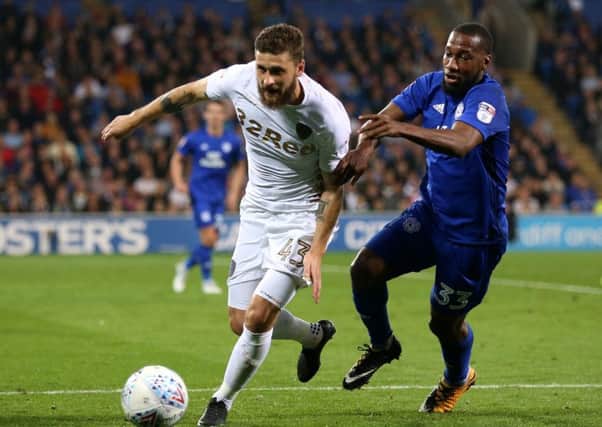 Leeds United's Mateusz Klich (left) and Cardiff City's Junior Hoilett battle for the ball Picture: Nigel French/PA