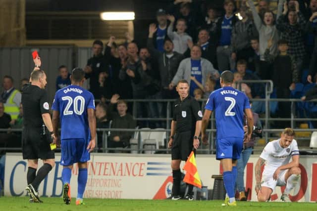 Referee Kevin Friend show Liam Cooper the red card following a challenge on Nathaniel Mendez-Laing.