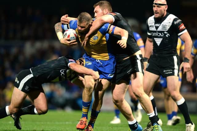 Mitch Garbutt is held by Danny Houghton and Scott Taylor.